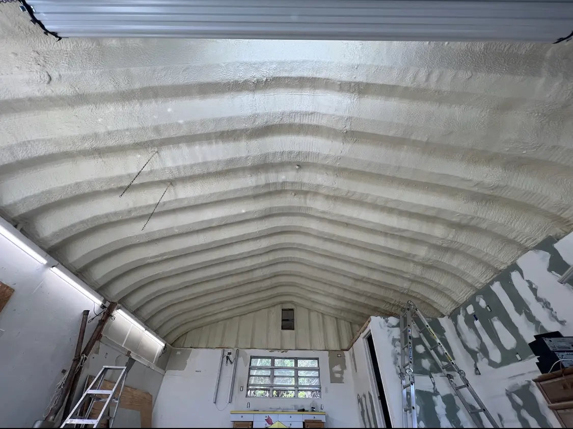 Spray polyurethane foam applied to the underside of a metal roof deck in East Hanover